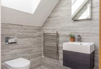 The bathroom has luxurious touches such as a light-up mirror and heated towel rails.