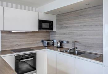 The polished kitchen boasts a quality finish and modern amenities.