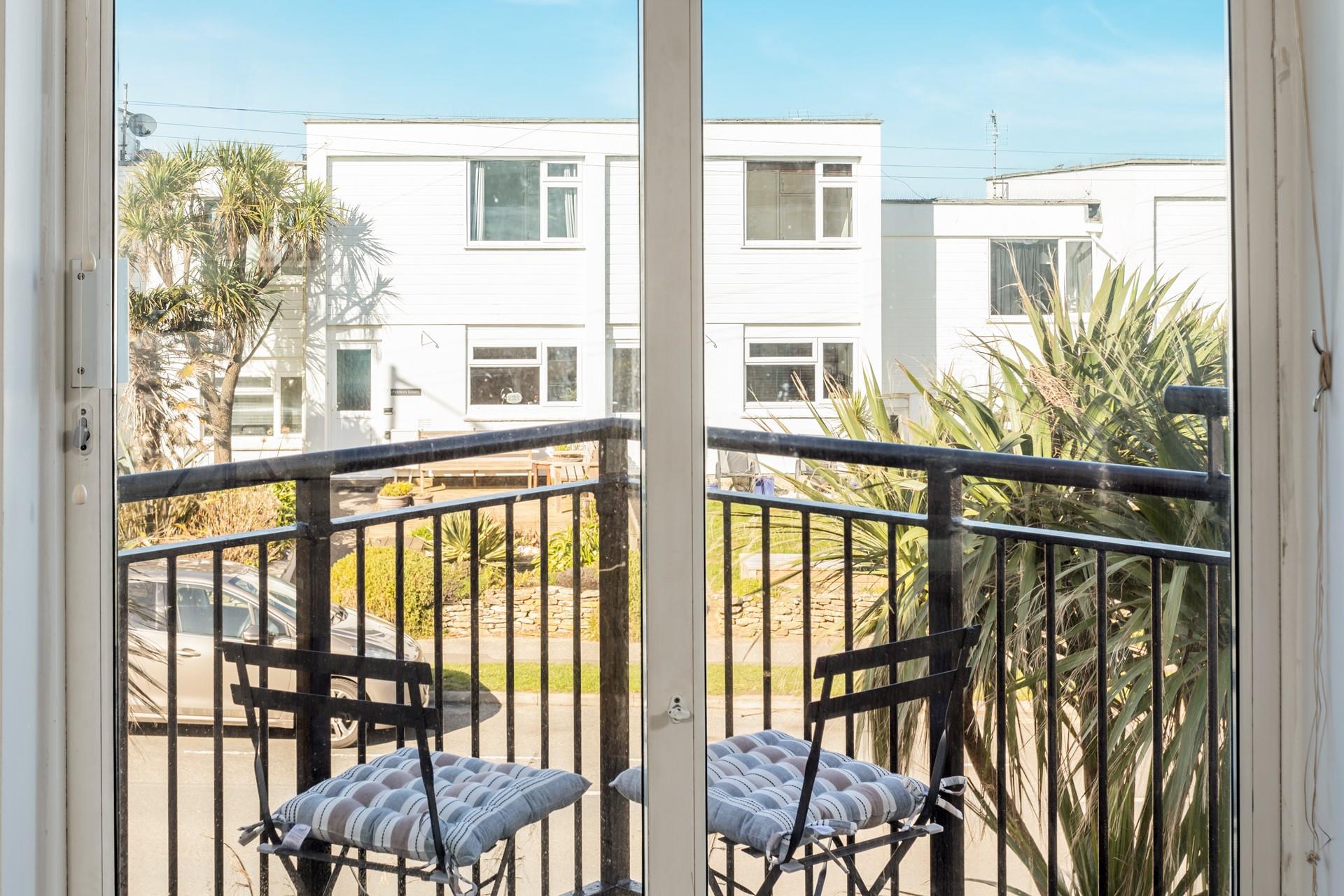 Sit out on the balcony and watch the comings and goings with a glass of something cold in hand.