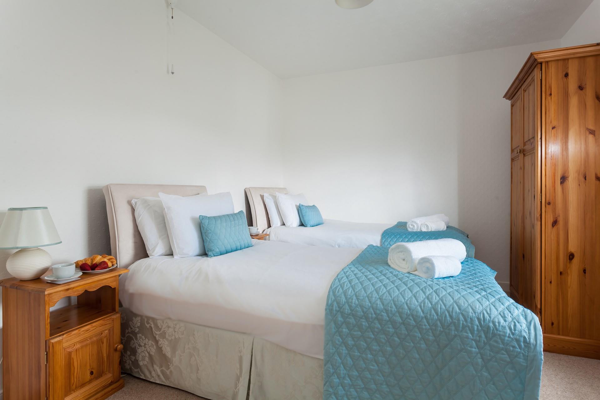 Bedroom 2 has calming blue tones to reflect the close proximity to the sea.