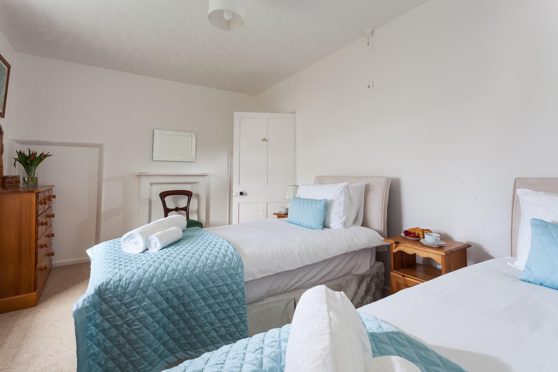 The bedroom is spacious and light for two guests.