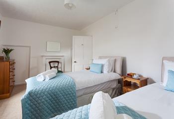 The bedroom is spacious and light for two guests.