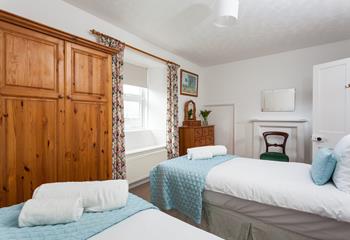 Bedroom 2 has twin beds perfect for adults or children to enjoy a relaxing night's sleep.