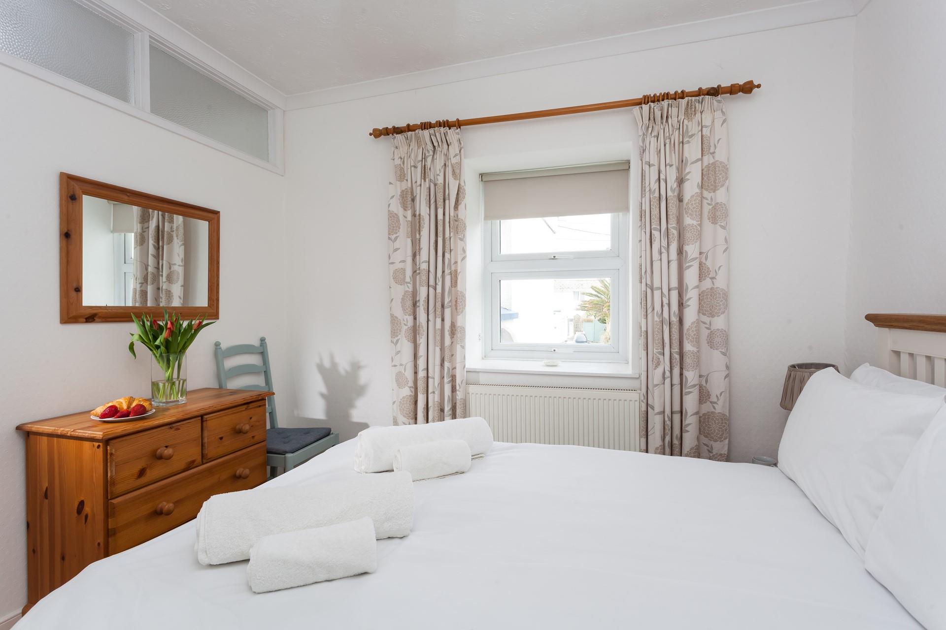 Bedroom 1 overlooks the garden and is simply decorated with homely touches.