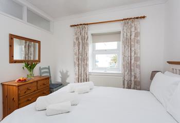 Bedroom 1 overlooks the garden and is simply decorated with homely touches.