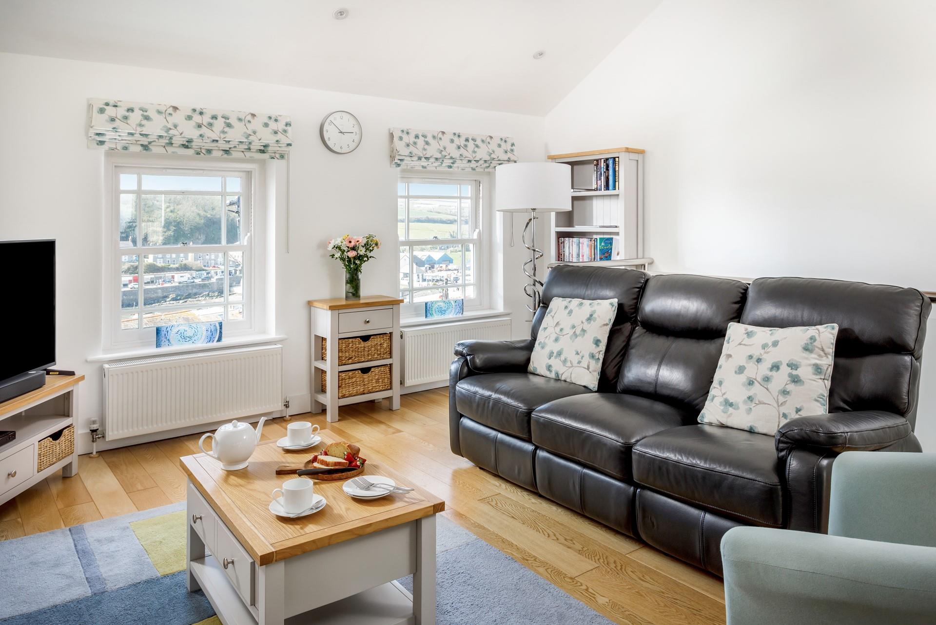 The sitting room has leather sofas and cosy furnishings for relaxing in the evenings.