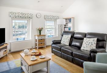 The sitting room has leather sofas and cosy furnishings for relaxing in the evenings.