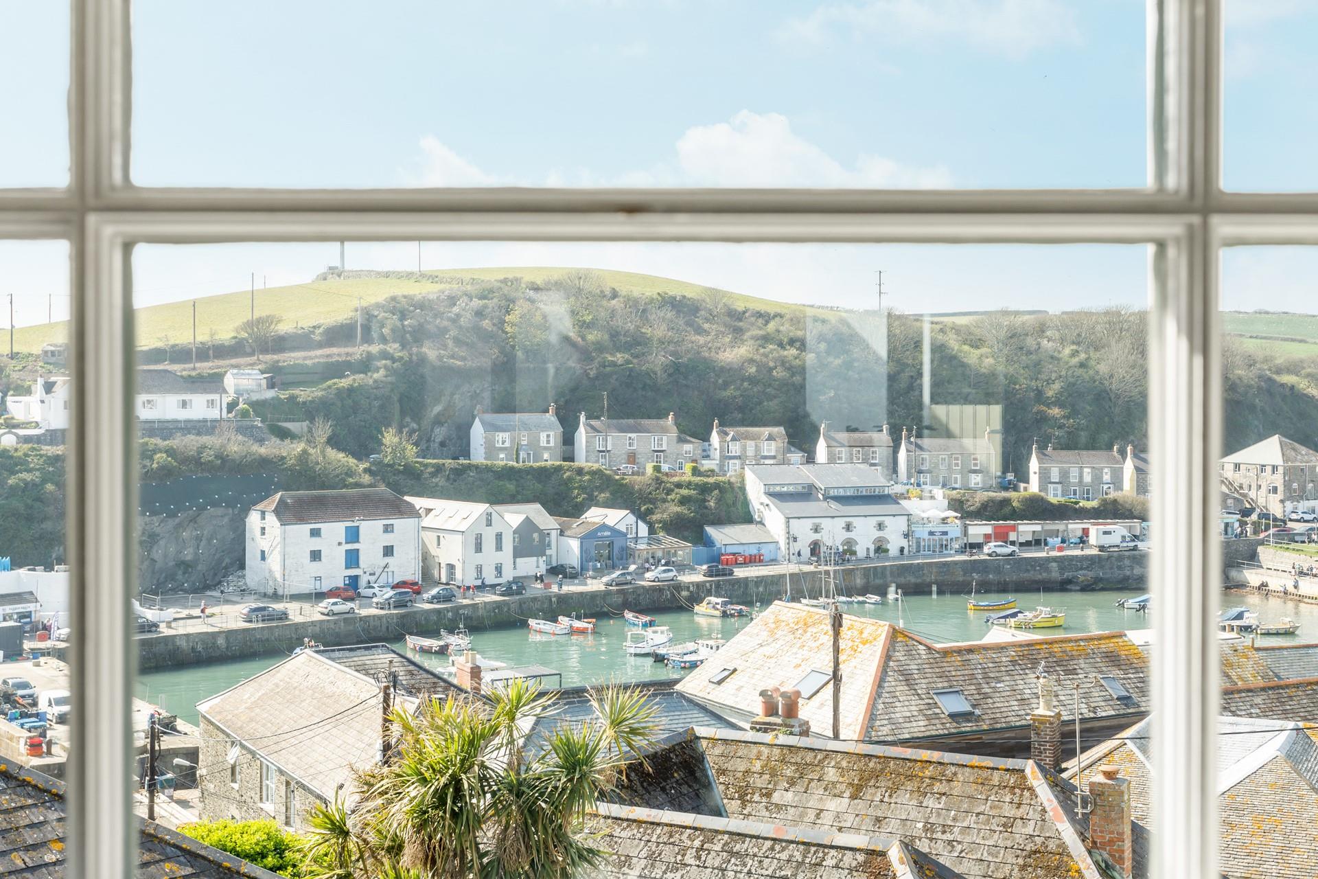 Watch the idyllic scene of the boats bobbing in the harbour from the window.
