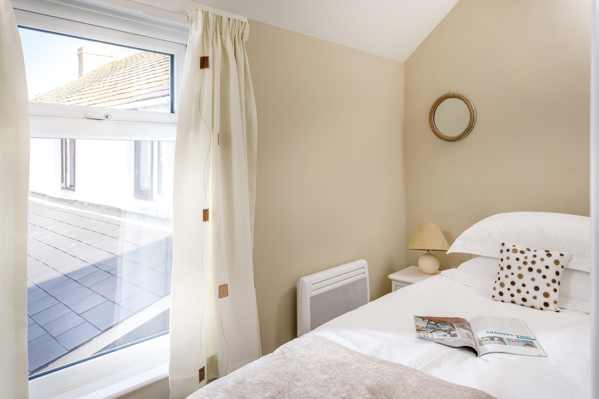 Bedroom 2 has a cosy single bed offering a peaceful night's sleep.