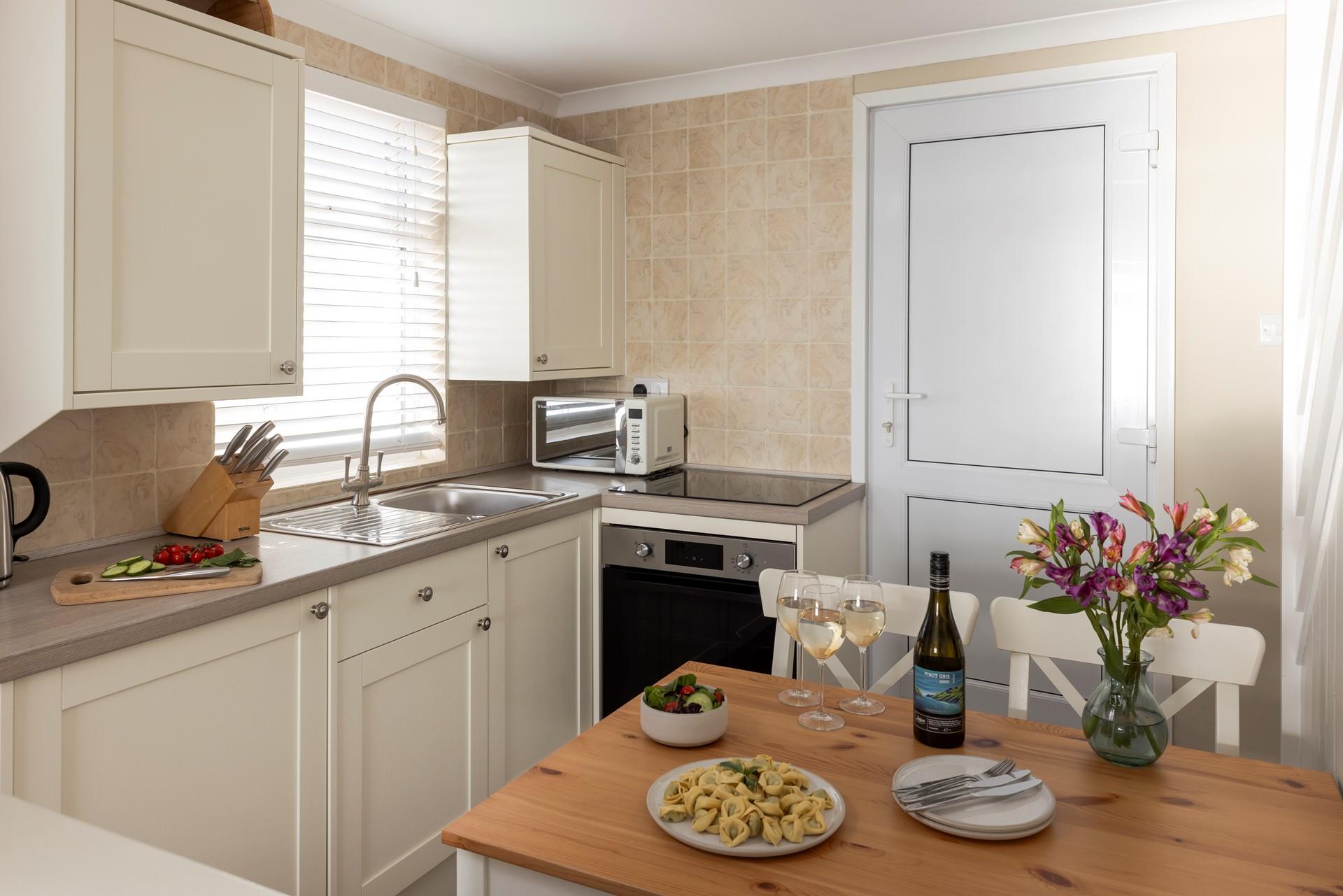 The compact kitchen is well-equipped with all you need.
