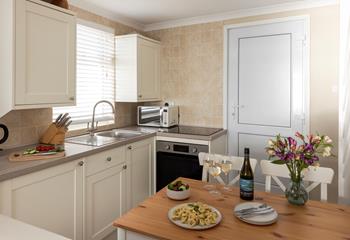 The compact kitchen is well-equipped with all you need.
