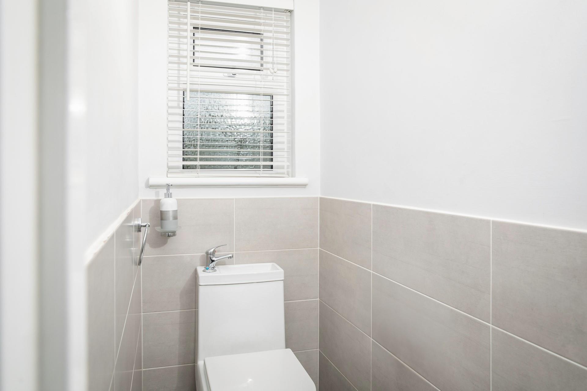 The cloakroom has a WC and basin.