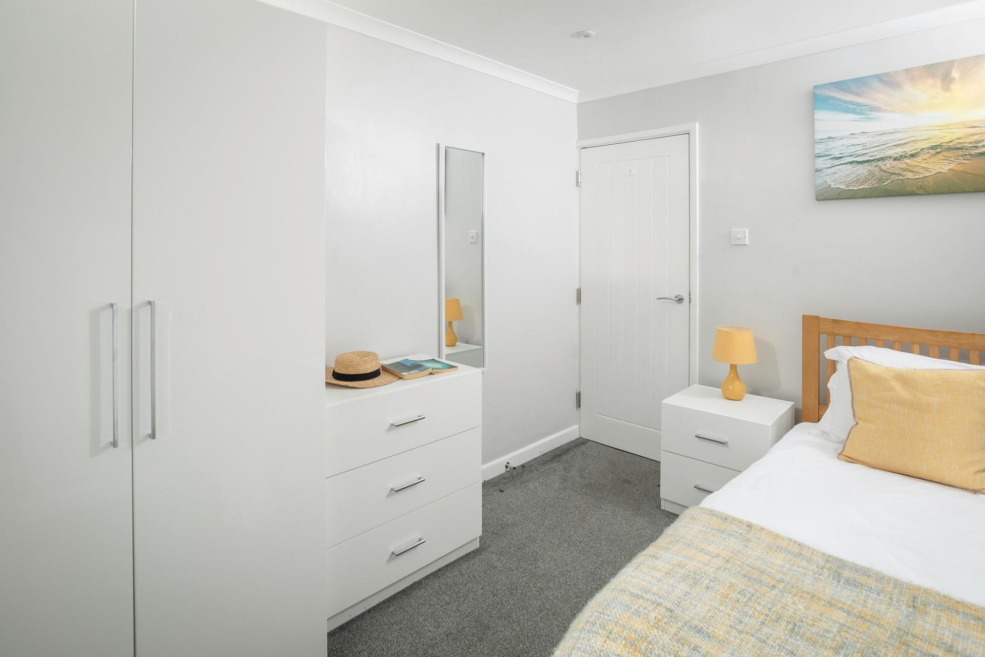 Bedroom 3 has a single bed and lots of storage space.