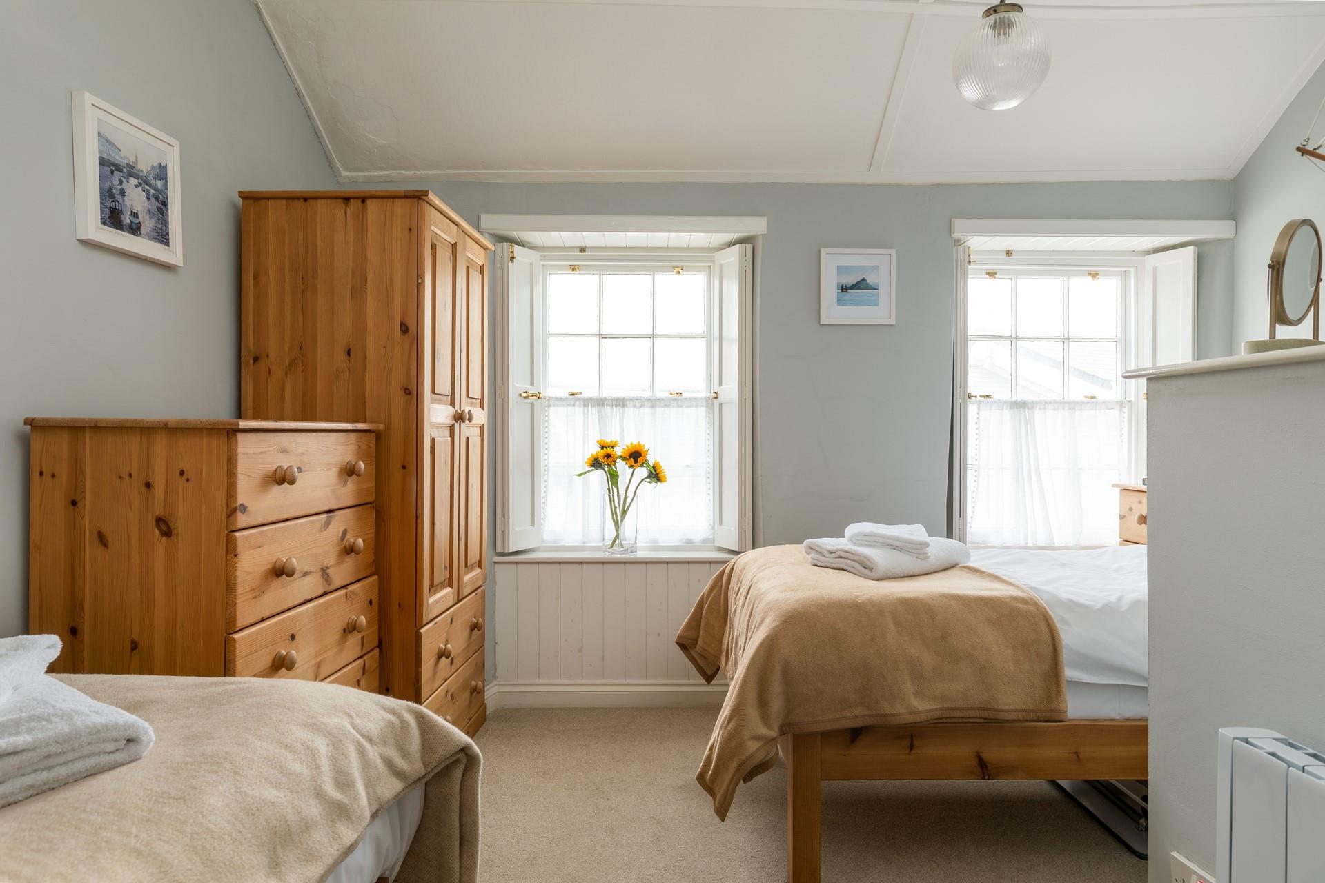 The two sash windows allow for the bedroom to be bright and airy.