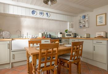 The country-style kitchen is modern and well-equipped for cooking delicious meals.