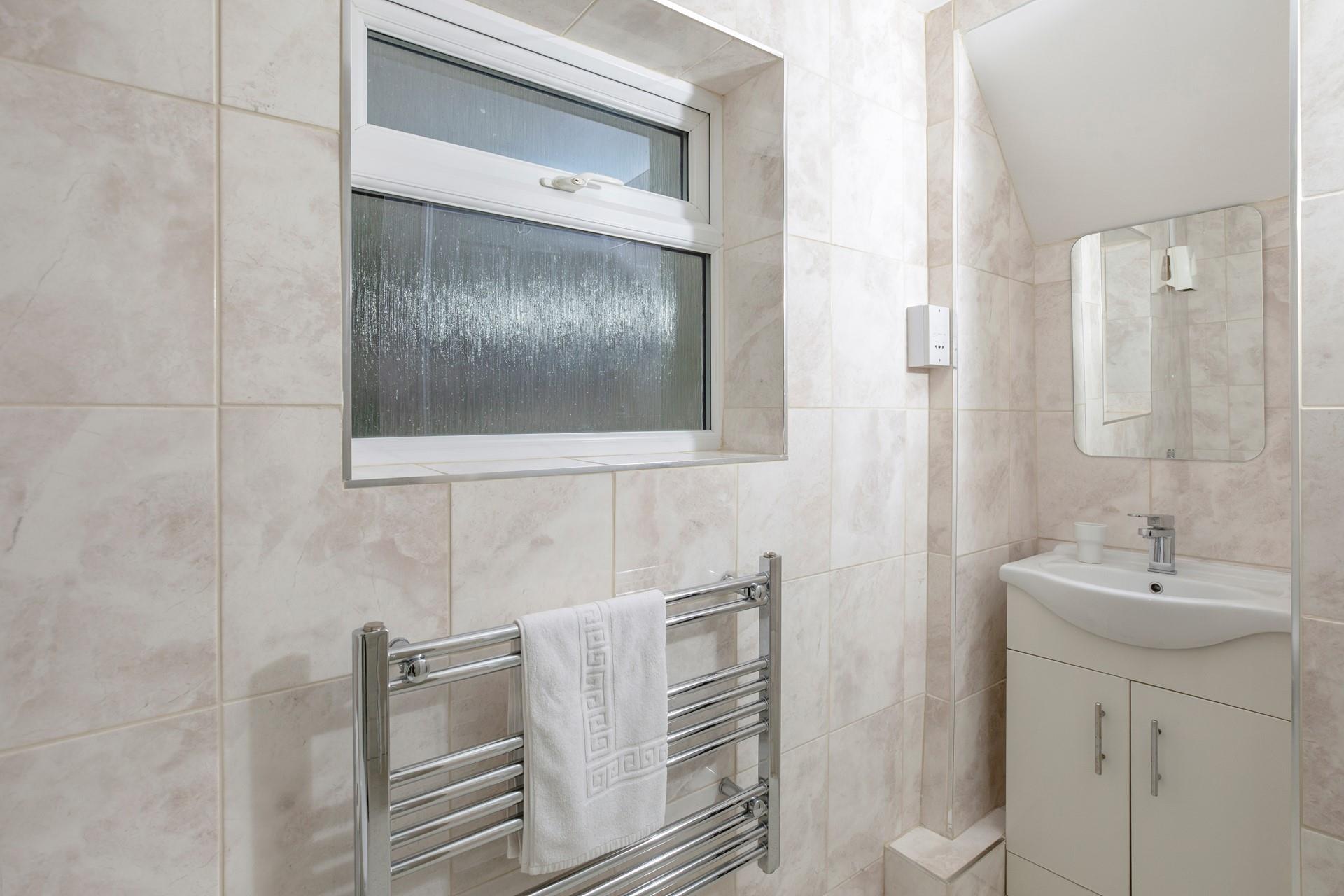 The shower room has a heated towel rail for the luxury of warm fluffy towels after a morning shower.