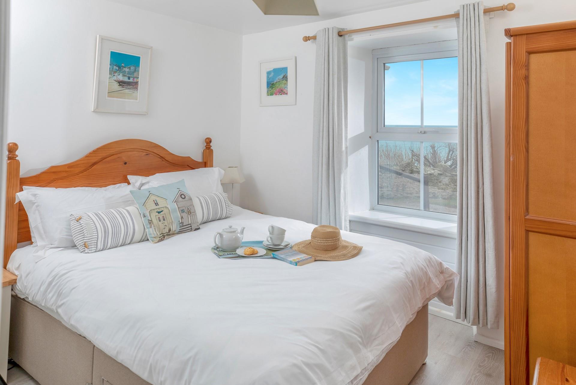 Bedroom 1 has a spacious king size bed and calming blue decor.