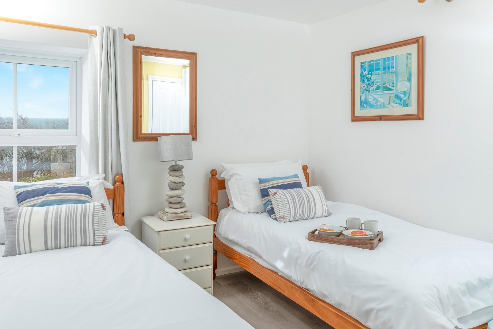 Calming blues and greys in bedroom 2 create a lovely space to relax in the evenings.