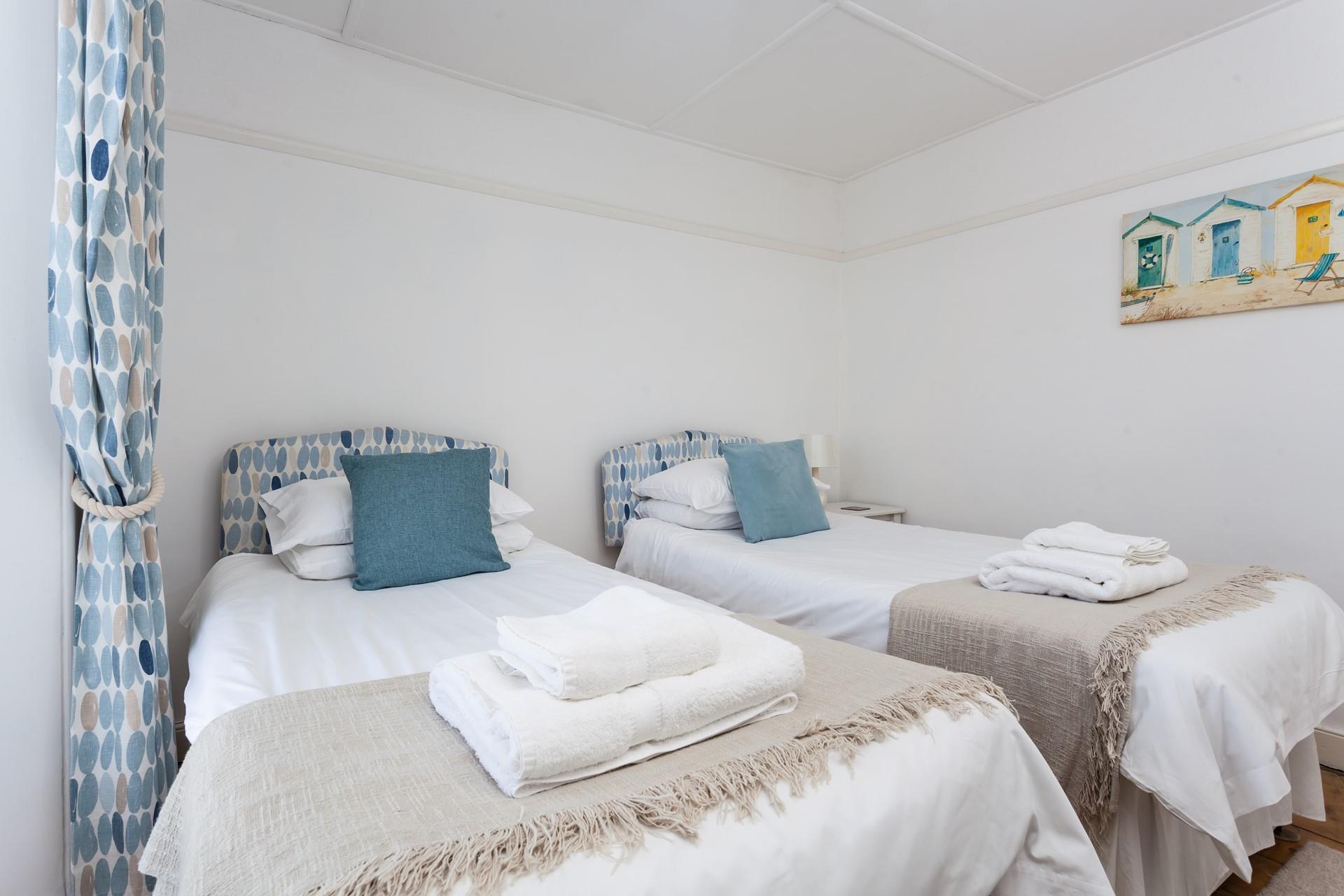 The beach hut artwork adds a pop of colour to the bedroom.