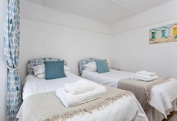 The beach hut artwork adds a pop of colour to the bedroom.