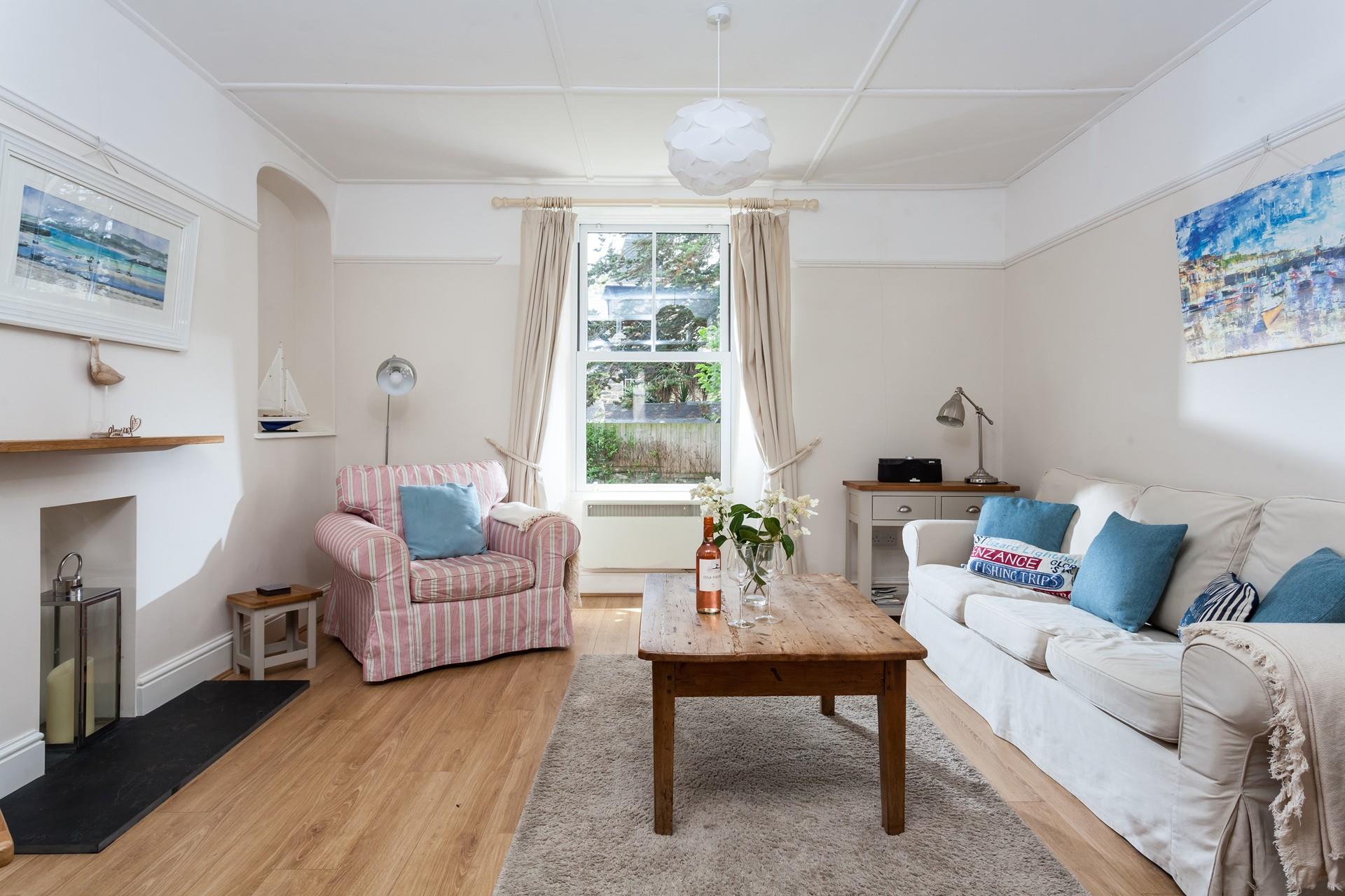 Cornish scenes fill the walls in the nautical-themed sitting room.