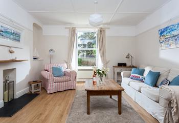 Cornish scenes fill the walls in the nautical-themed sitting room.