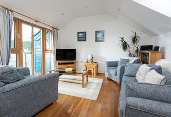 Calming blue tones reflect the close proximity to the sea in the cosy sitting room.