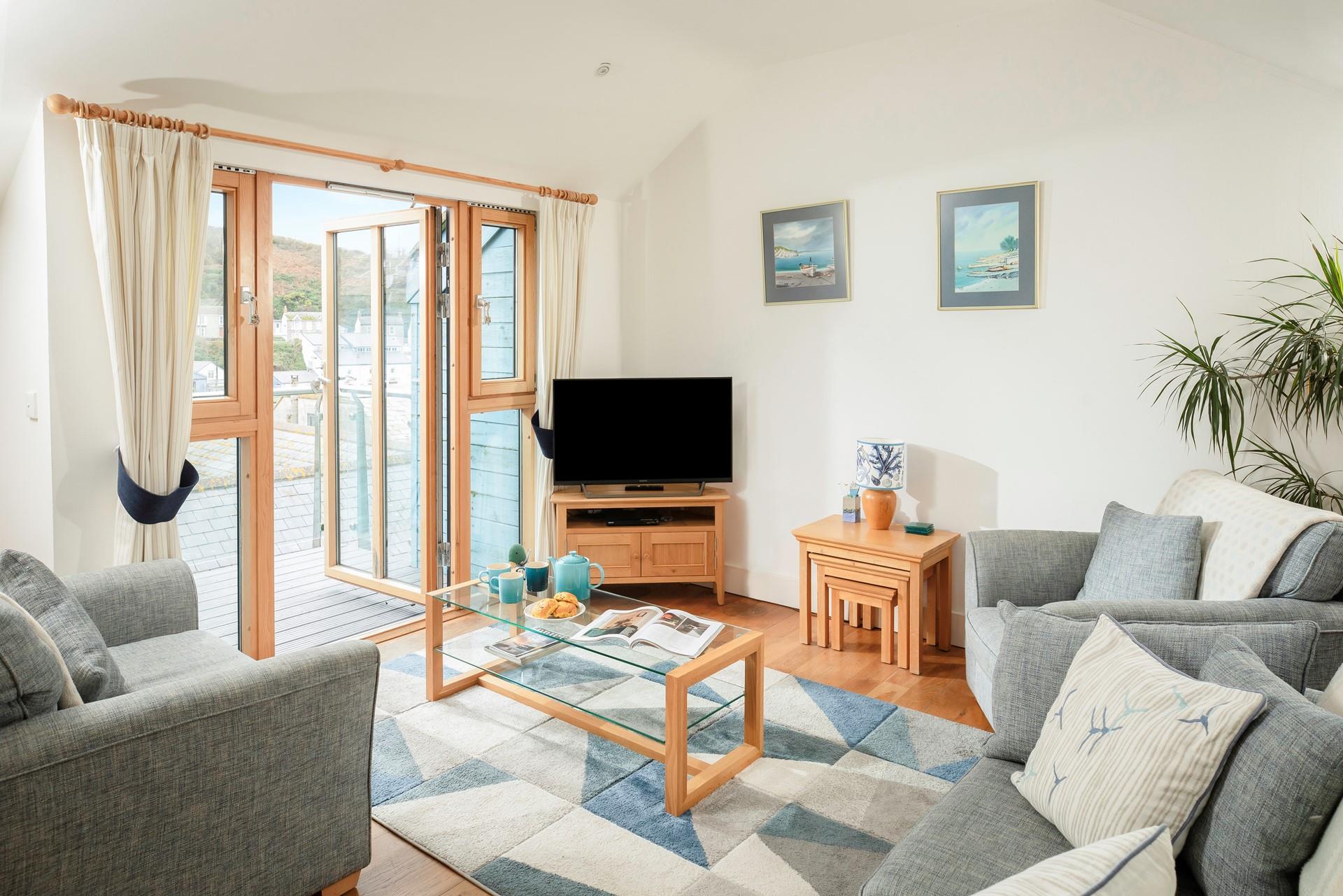 Calming blue tones reflect the close proximity to the sea in the cosy sitting room.