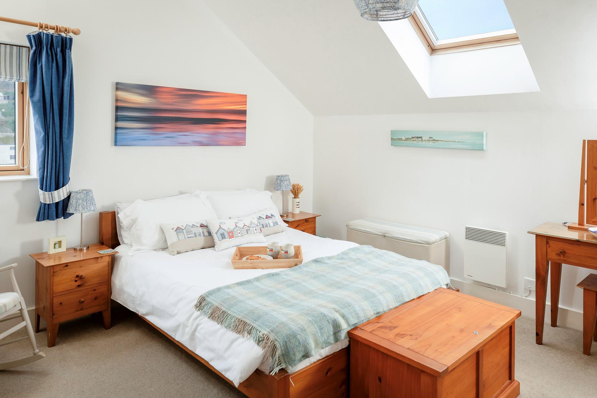 Relax in the soft sheets of the king size bed, enjoying a dreamy night's sleep after a memorable day.