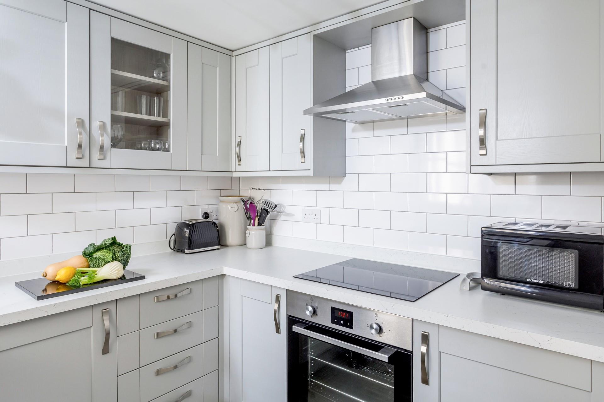 The stylish modern kitchen is fully equipped for all your culinary needs.