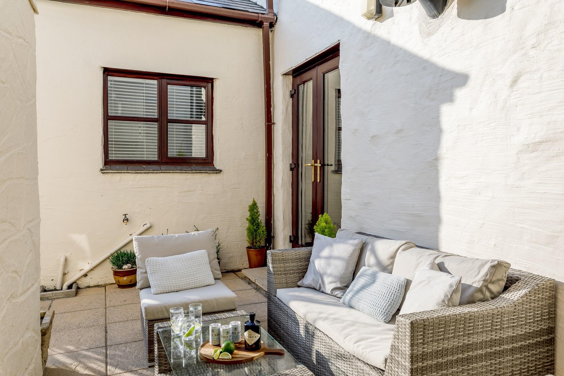 Relax in the courtyard on the rattan furniture with a cold drink in hand.