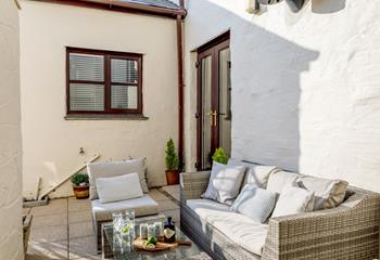 Relax in the courtyard on the rattan furniture with a cold drink in hand.