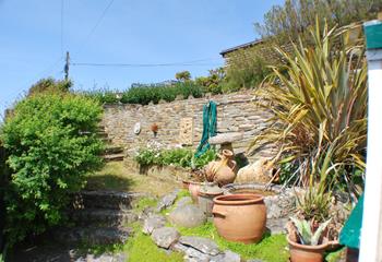 The stone-walled garden offers privacy and amazing sea views.