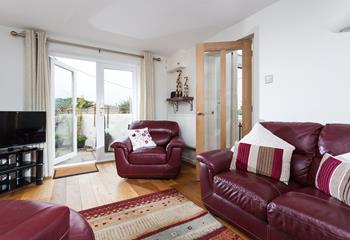 The sitting room leads out to the enclosed garden.