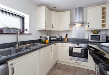 The kitchen is modern and well-equipped for cooking tasty meals.