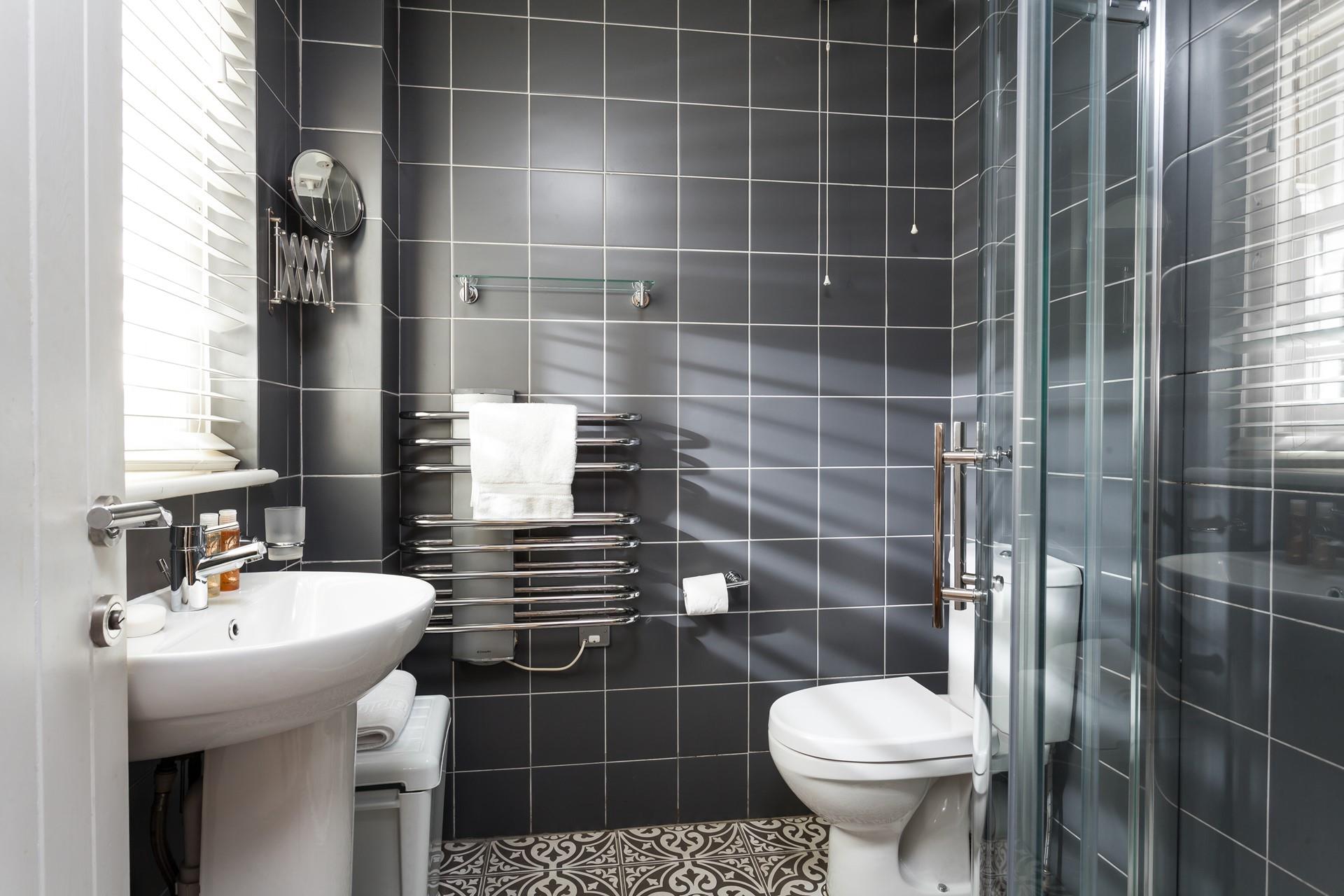 The stylish en suite offers an invigorating morning shower.