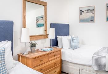 Quirky Cornish artwork fills the walls in bedroom 2.