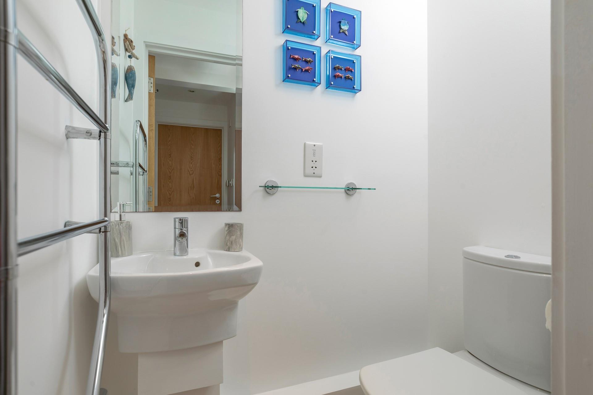 The cloakroom has a WC and basin.