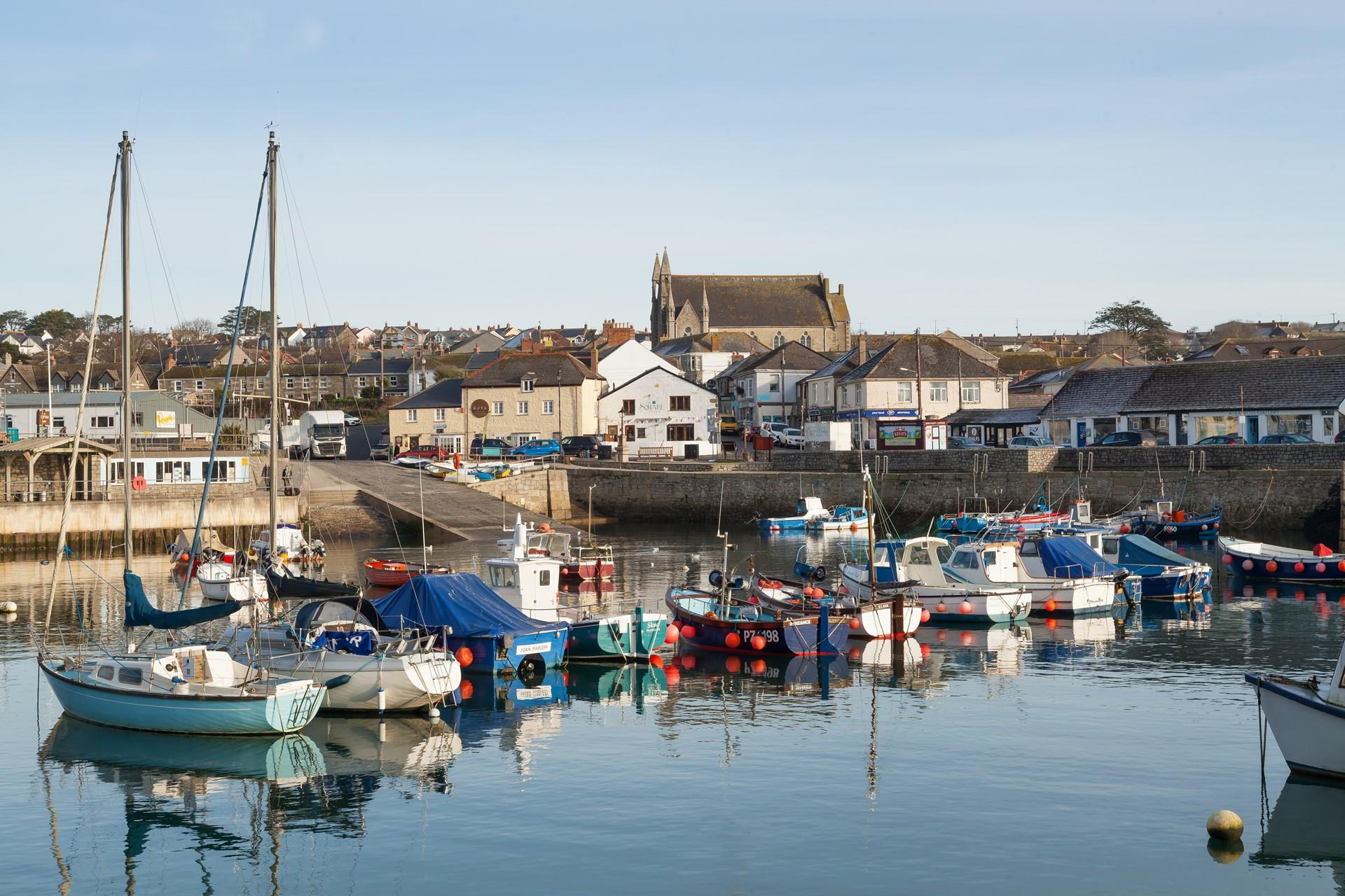 As the sun rises, the boats bobbing on the glistening water make for the perfect backdrop.