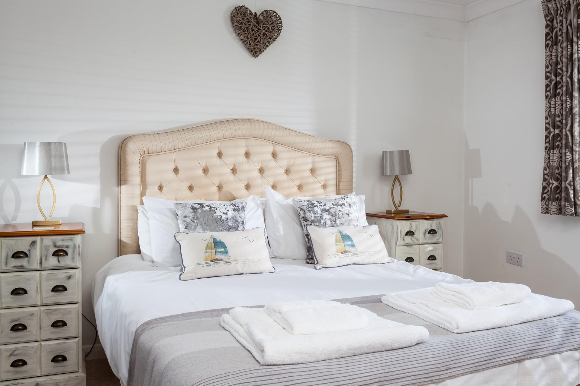 Bedroom 1 has a spacious king size bed and overlooks the leafy garden.