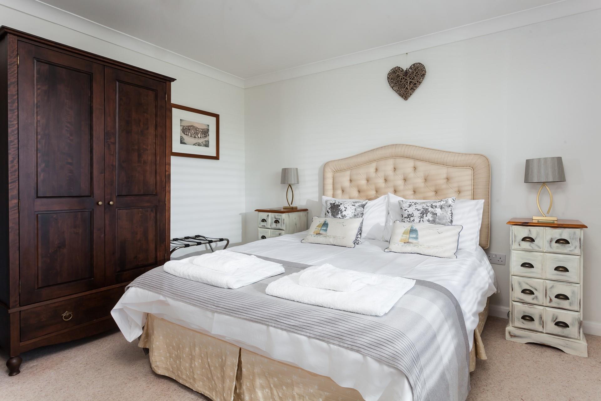 The comfortable bedroom has storage space and homely decor.