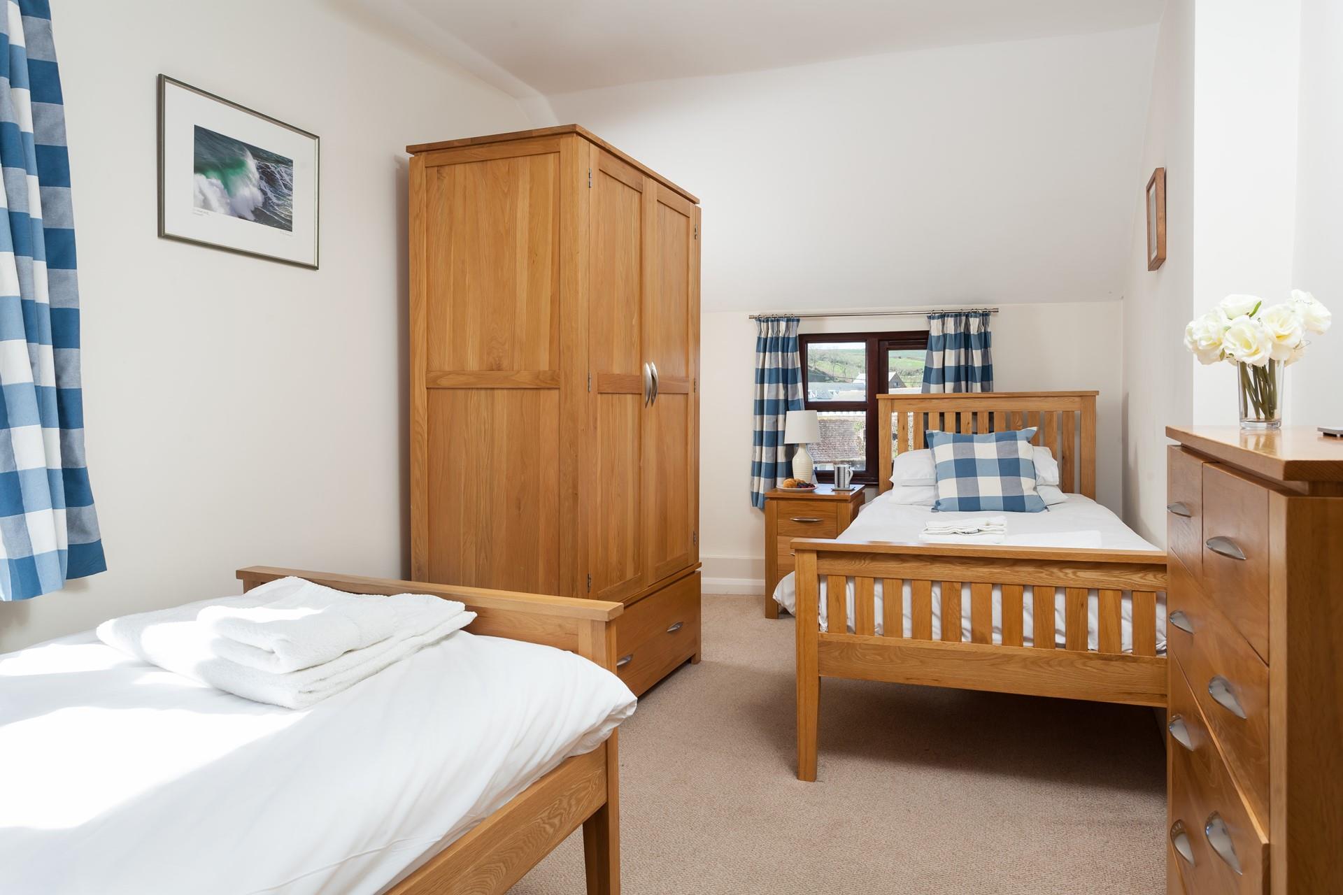 The twin room is decorated with blues and whites to reflect the proximity to the ocean.