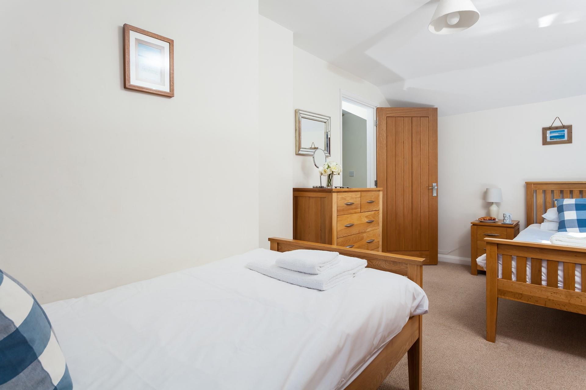 Bedroom 2 is spacious and light with lots of storage space.