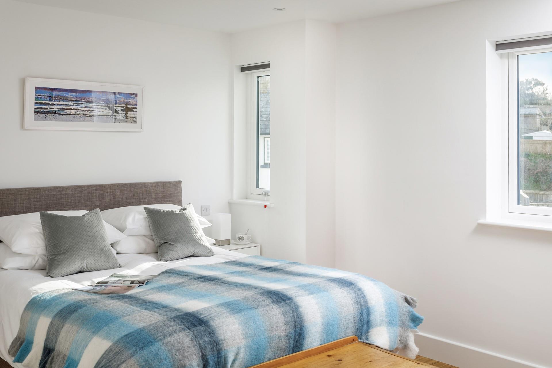 The main bedroom has a spacious king size bed and calming blue tones.