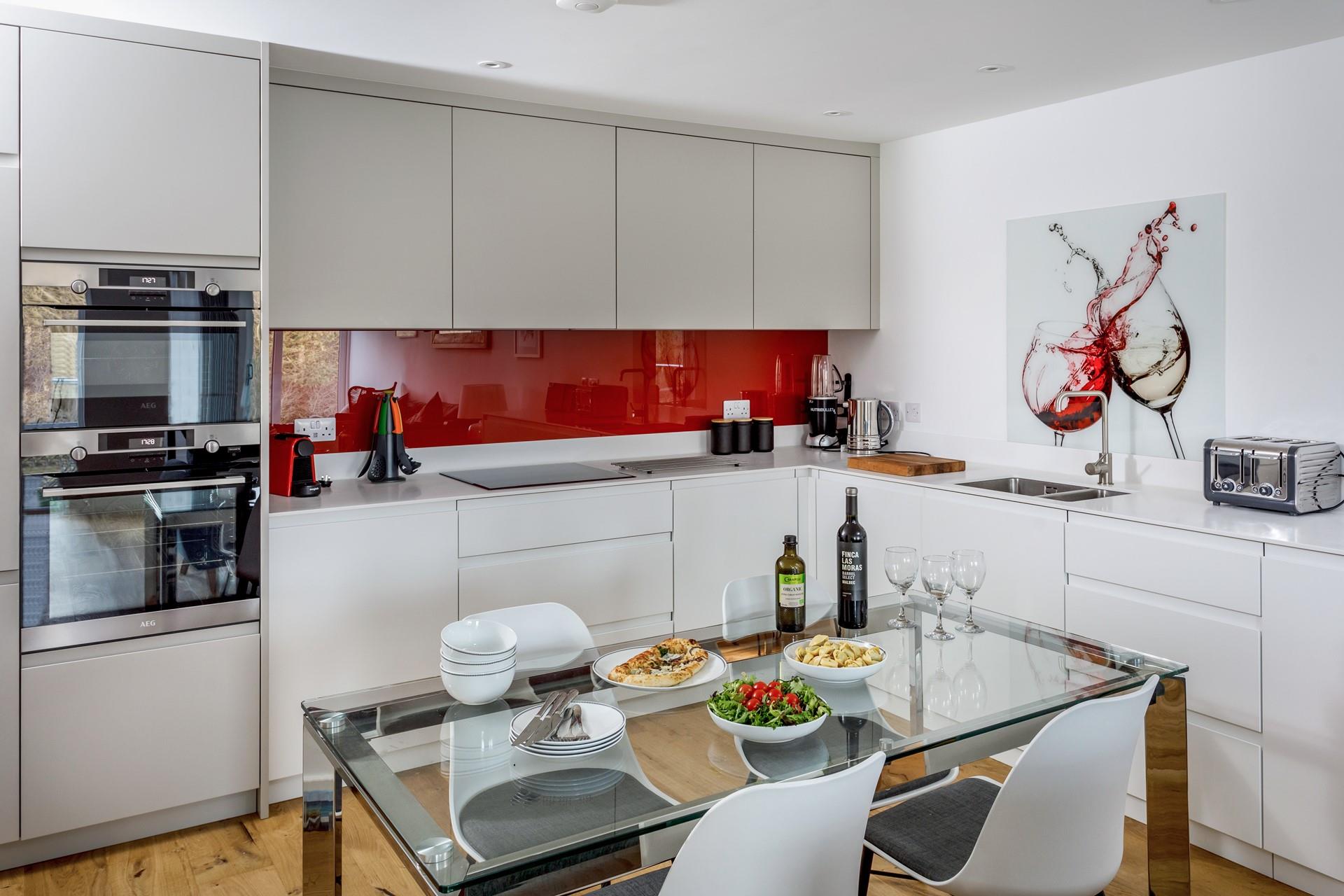 The kitchen is modern and sleek with all the extras including a coffee maker and Nutribullet.