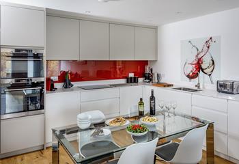 The kitchen is modern and sleek with all the extras including a coffee maker and Nutribullet.