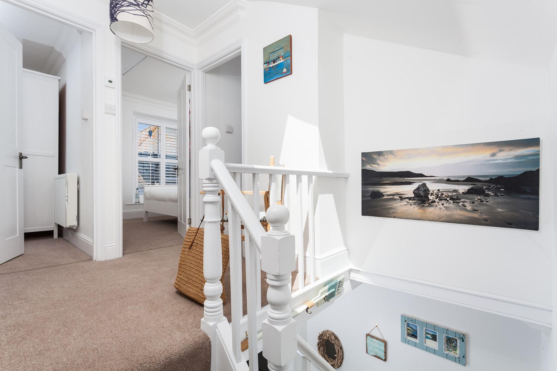 Cornish coastal scenes fill the walls of this lovely cottage.