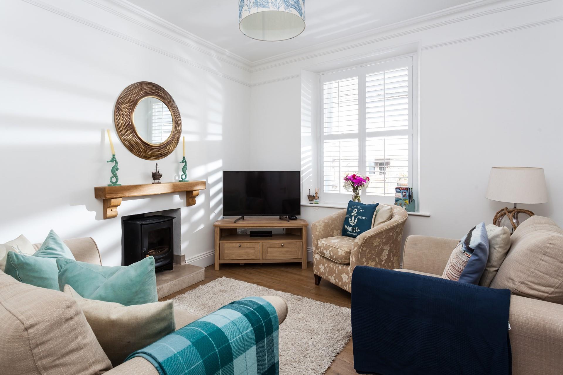 Bright beachy blues in the cosy sitting room create a calming space to relax.
