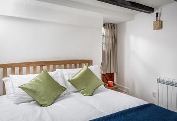 The bedroom has a spacious king size bed offering a cosy night's sleep.