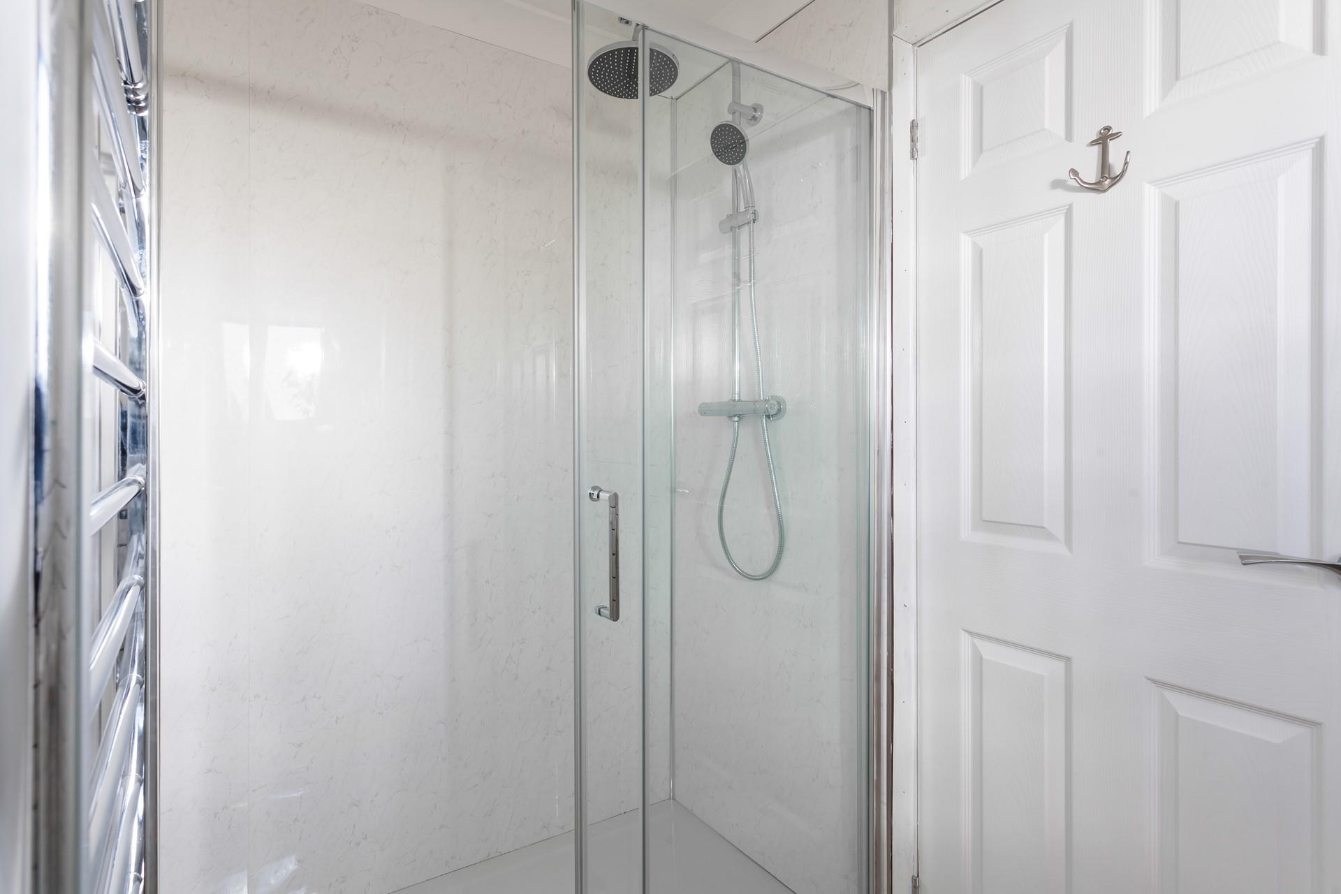 Wash off those sandy toes in this large walk-in shower room. 